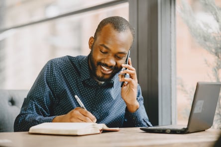 african-american-man-working-laptop-talking-phone-man-with-beard-sitting-cafe-1536x1024