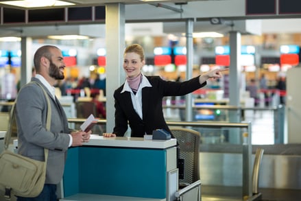 airline-check-attendant-showing-direction-commuter-check-counter
