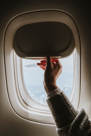 woman-opening-window-shade